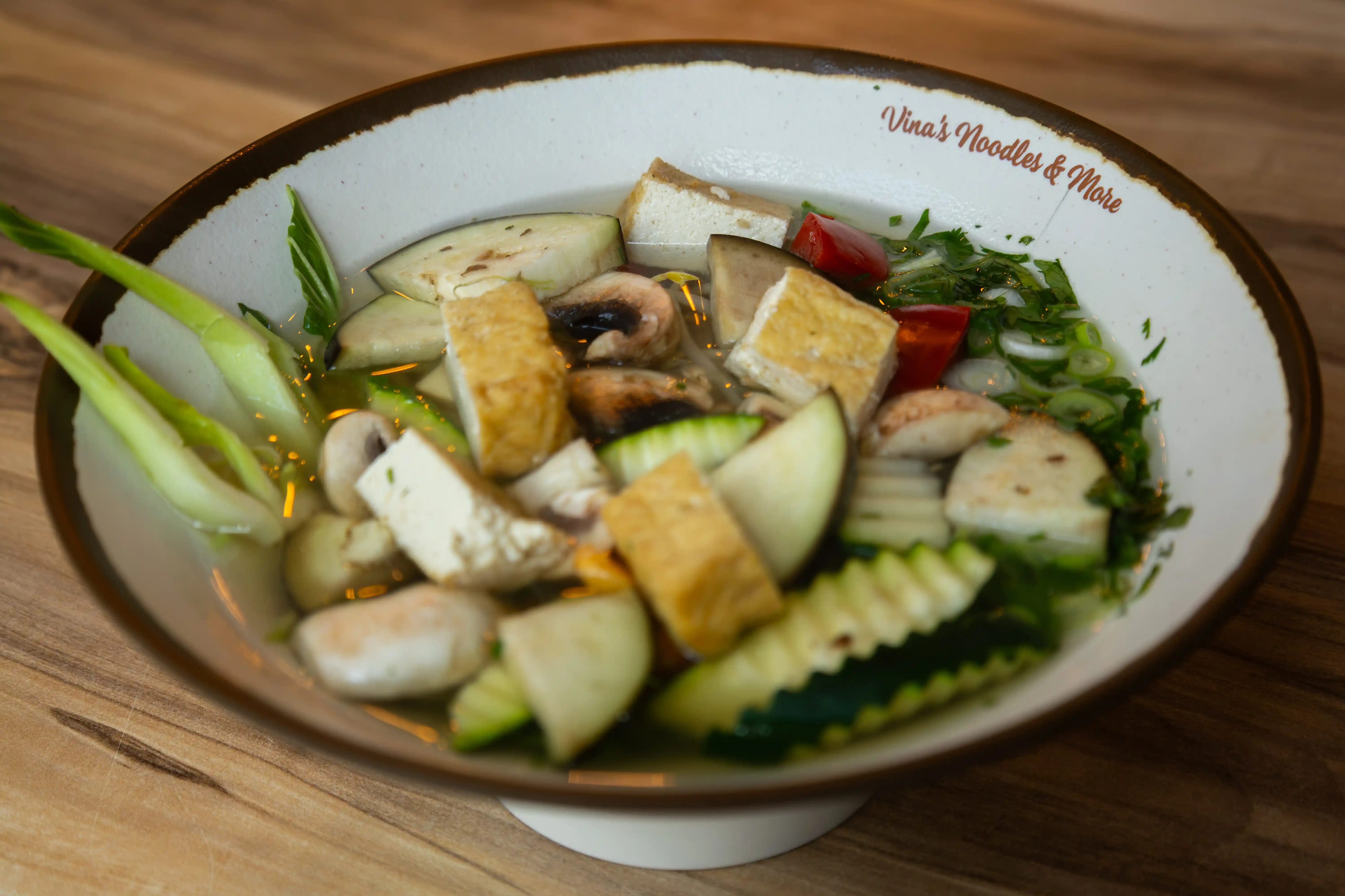 A bowl of Vietnamese vegetarian pho with tofu and vegetables